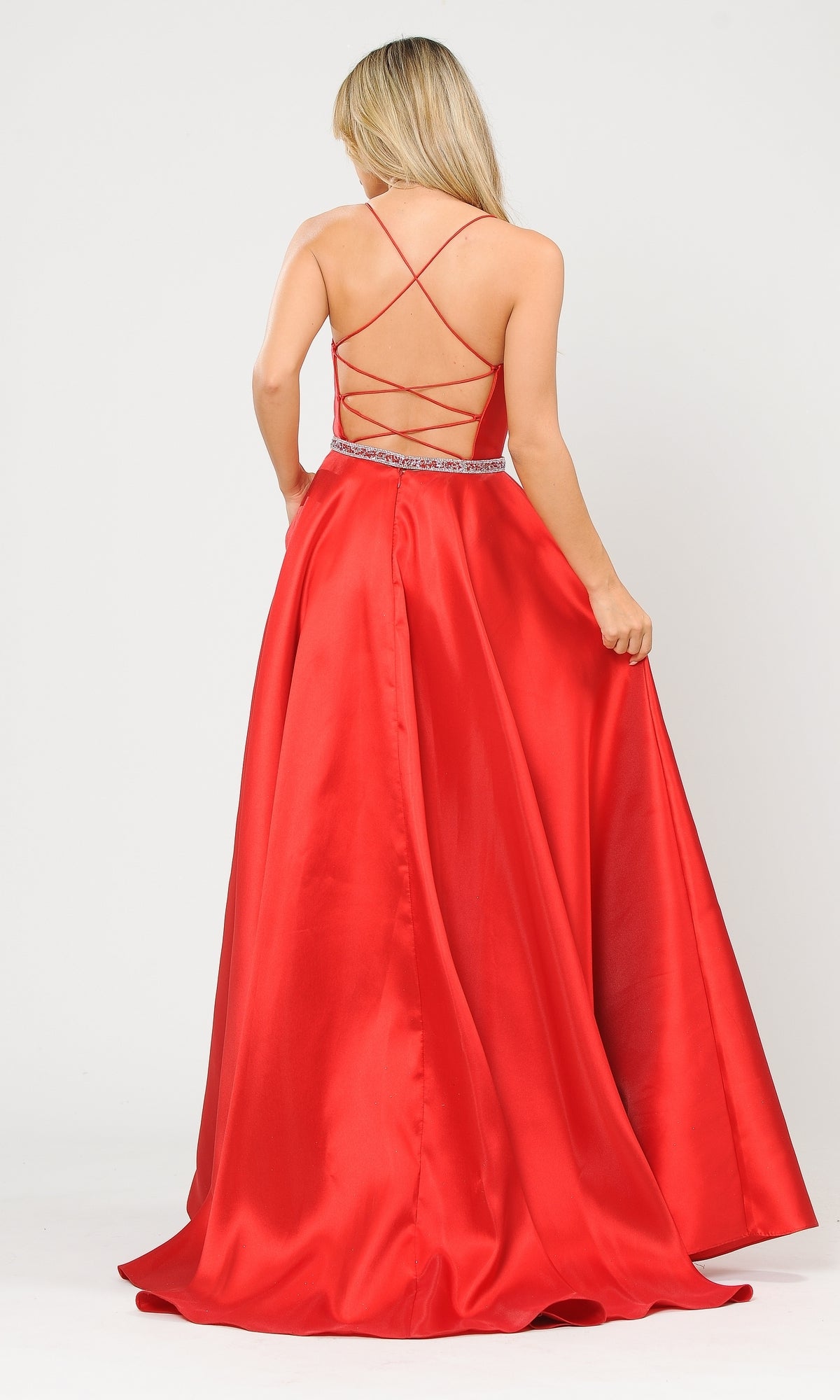 A woman faces away, holding out one side of the Strappy-Back Long Mikado A-Line Prom Dress 8688, a red, floor-length gown with a strappy open back.
